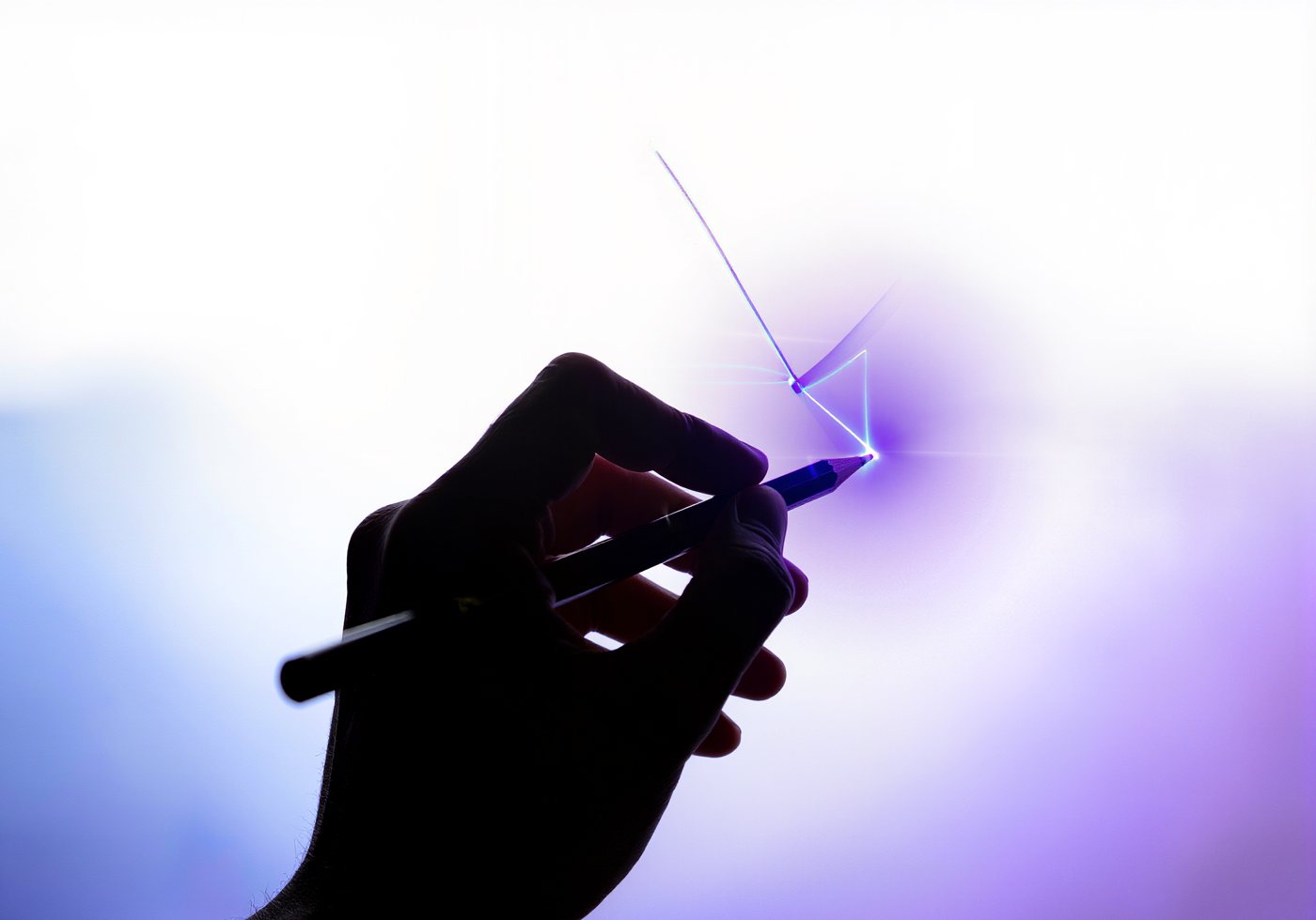 A hand drawing a glowing line with a pencil